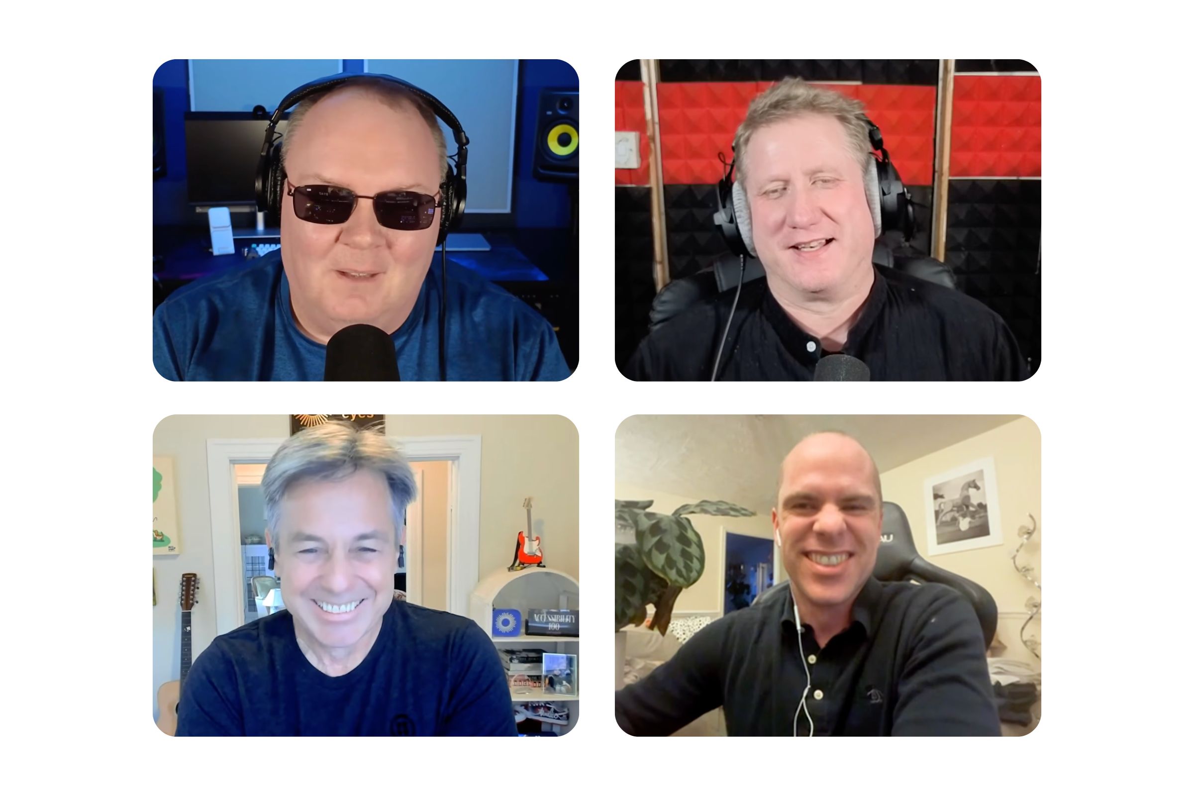 A four-panel video-call style image showing four adult men wearing headphones and speaking into microphones. Top left: A light-skinned, bald man wearing dark sunglasses, large black over-ear headphones, and a blue shirt. A black microphone is in front of him. The background appears to be a studio setup with a monitor and a speaker, lit with cool blue lighting. Top right: A light-skinned man with short blond hair wearing large over-ear headphones and a dark shirt. A microphone is in front of him. The background is covered with red-and-black acoustic foam panels. Bottom left: A light-skinned man with short gray hair smiling, wearing small in-ear earbuds and a dark shirt. The background looks like a home room with a doorway, a guitar, and shelves. Bottom right: A light-skinned, bald man smiling broadly, wearing wired in-ear earbuds and a dark collared shirt, seated in an office-style chair. The background shows a plant and framed wall art. Description via Be My AI